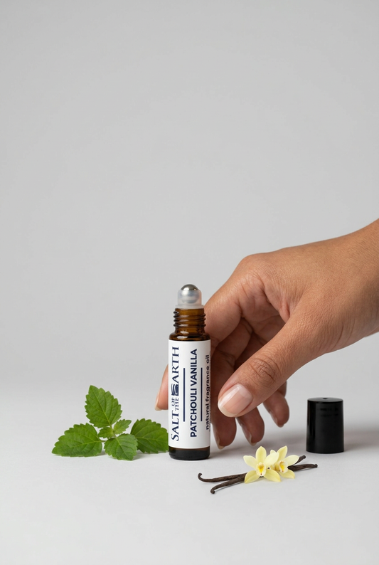 Patchouli Vanilla fragrance oil roller bottle beside a hand for scale